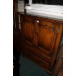 A reproduction oak TV cabinet