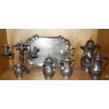 A set of four graduated continental pewter coffee pots, a similar jug, a tray and a two branch