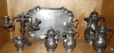 A set of four graduated continental pewter coffee pots, a similar jug, a tray and a two branch