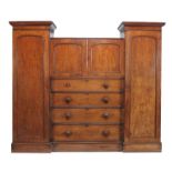 A William IV mahogany compactum, circa 1835, the central bookcase section enclosed by moulded