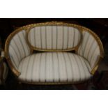 A gilt framed Louis XVI style canape with curved back on reeded supports.