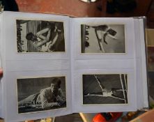 An Album containing an Olympic 1936 badge and related reproduction photos of athletes, Jessie Owens,