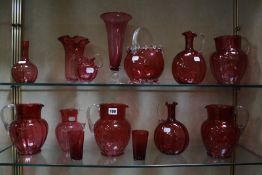 A quantity of cranberry glassware to include jugs, tumblers, vases etc -14