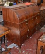 A Dutch mahogany roll top bureau, early 19th century with a fitted interior with drawers below.