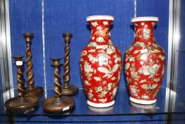 A pair of 20th Century Oriental vases, red ground decorated with butterflies, baluster shaped,