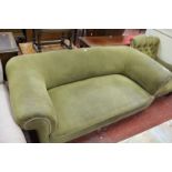 An Edwardian sofa with scroll arms and back on turned legs, brass caps, and castorsBest Bid