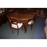 An Edwardian mahogany and satin wood banded extending dining table.