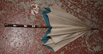 A silk parasol and an early 20th Century christening gown