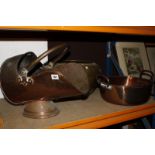 A copper helmet shaped coal scuttle, a copper preserving pan and a brass bowl