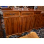 * A breakfront yew wood cabinet and a yew wood cabinetBest Bid