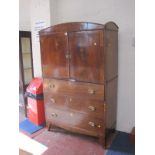 A Regency mahogany secretaire cabinet, the upper section enclosing shelves with two short and two