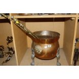 A copper and brass cauldron shaped coal box, three brass fireirons, a trivet, a resin figure of an