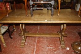 An oak refectory table on a trestle base. 169cm