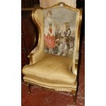 A gilt frame wing arm chair with an embroidered chair back