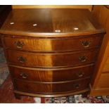 A Georgian style bow front chest of drawers.