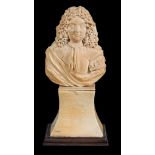 A relief carved ivory bust of a French nobleman, French, circa 1700, full face with long curly hair,