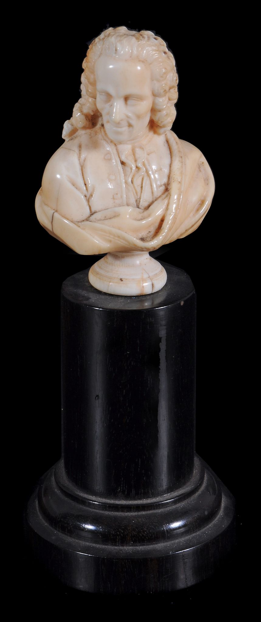 An ivory bust of Voltaire,   early 19th century,  on ebonised plinth , 7.5cm high