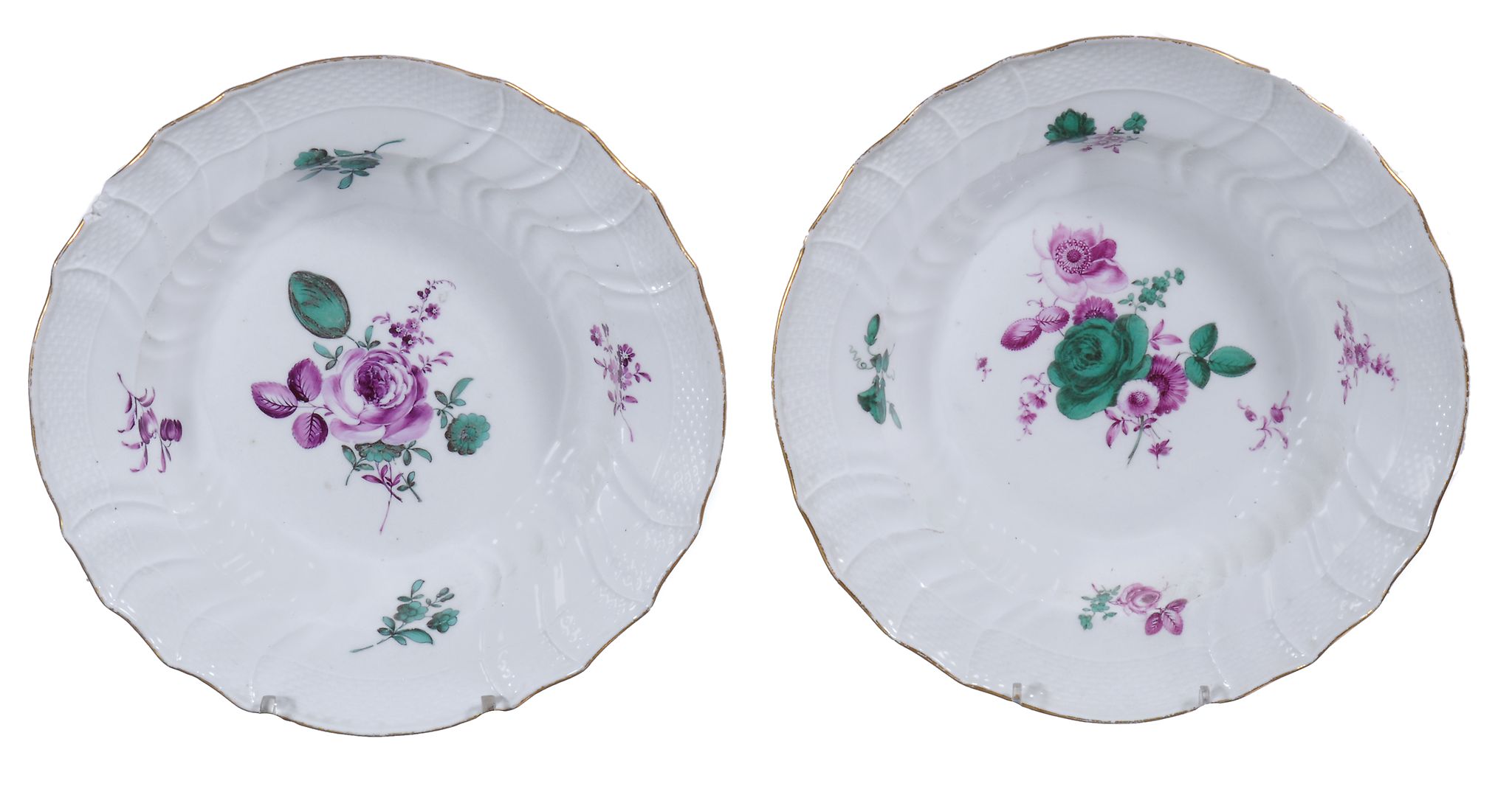 A pair of Meissen soup plates  , circa 1770,  painted with flowers in puce and green inside basket