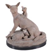 A Continental terracotta model of a vixen with cubs,   late 19th century, on a slate base, 15cm