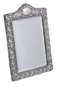 An Edwardian silver shaped rectangular dressing table mirror,   maker's mark  L   (not traced),