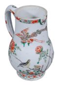 A famille verte jug  , Qing Dynasty, Kangxi (1662-1722),  of similar form, decorated with a bird on