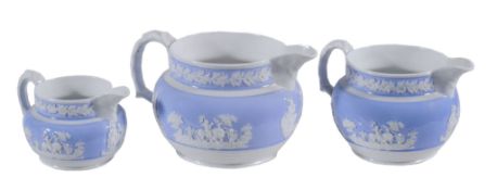 A graduated set of three Spode white stoneware jugs  , circa 1820,  each sprigged in white relief