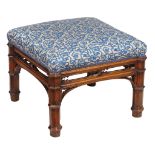 A Victorian Gothic Revival walnut stool  , circa 1860,  the stuffed square seat over a pierced