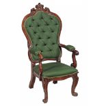 A Victorian rosewood armchair  , circa 1850,  with an arched padded back, padded arms and padded