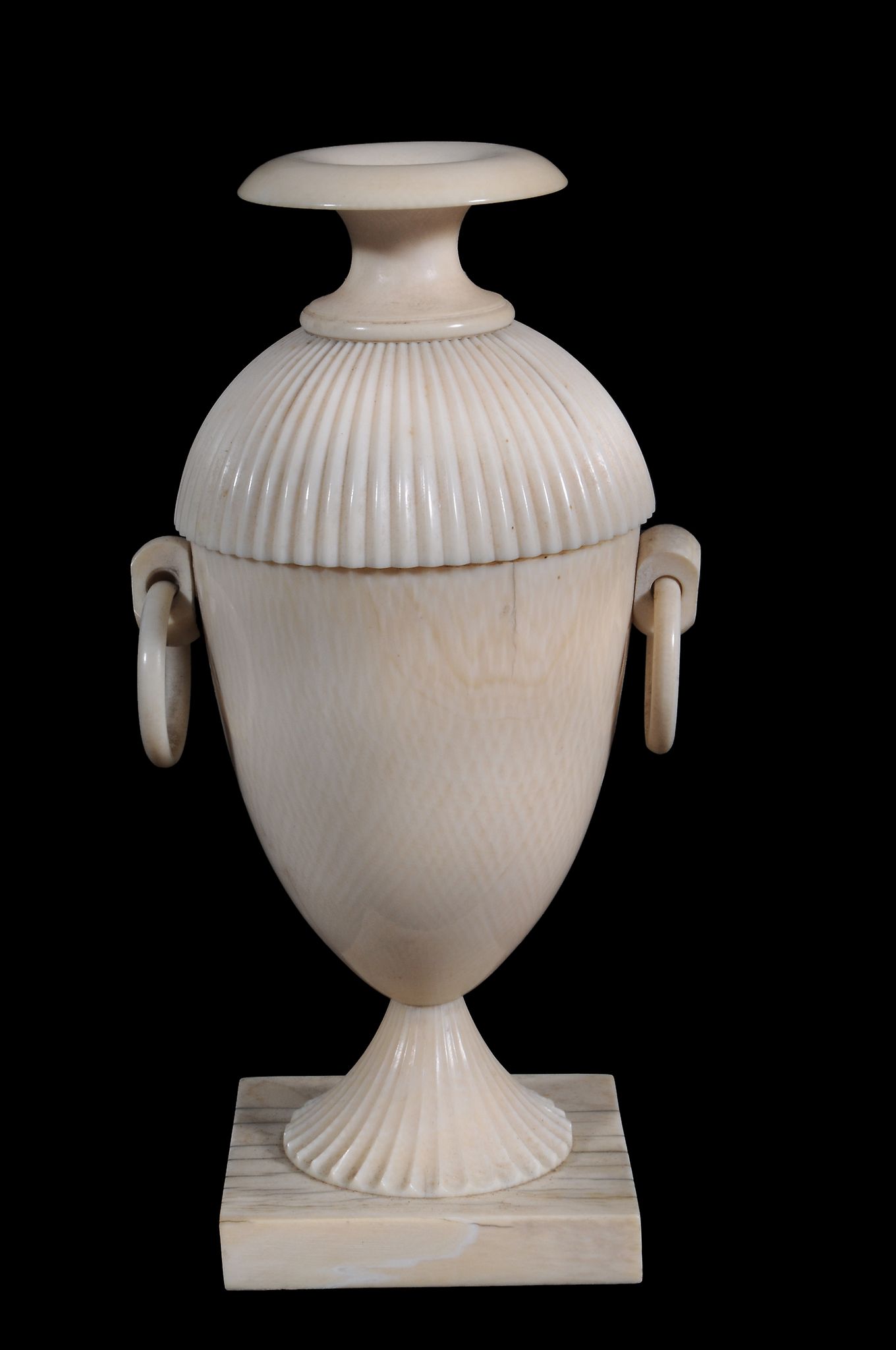 An ivory urn and cover,   early 19th century,  with fluted domed lid and foot and twin ring