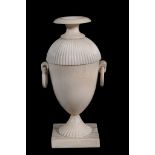 An ivory urn and cover,   early 19th century,  with fluted domed lid and foot and twin ring