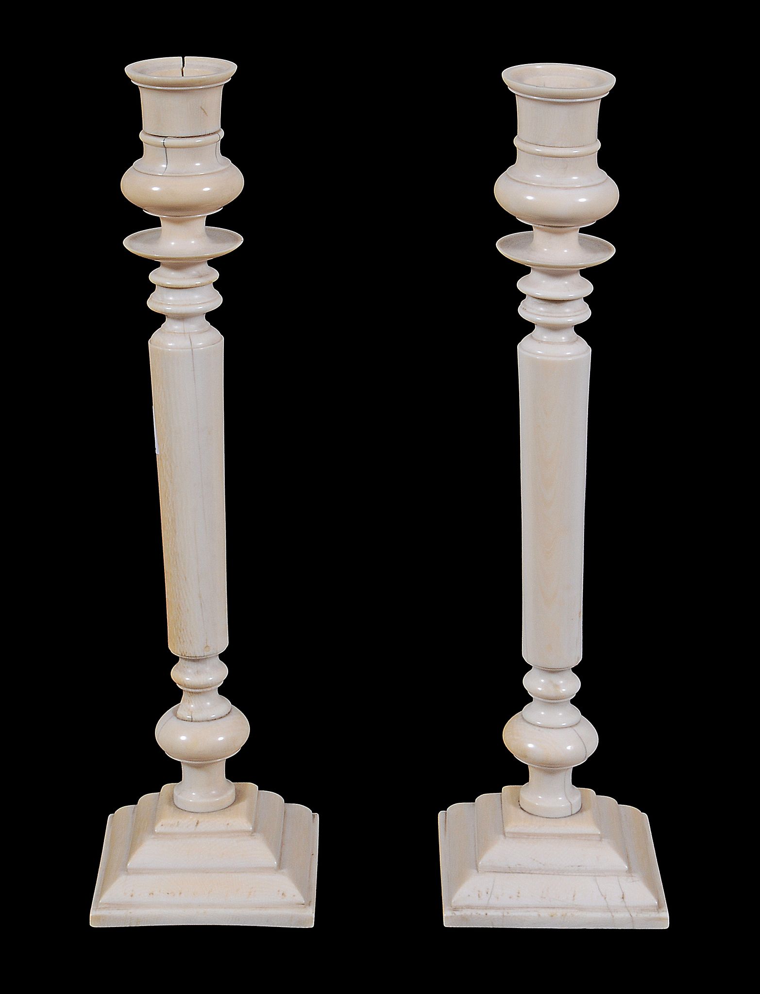 A pair of ivory candlesticks,   probably Anglo-Indian, late 19th century , with waisted sockets and