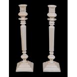 A pair of ivory candlesticks,   probably Anglo-Indian, late 19th century , with waisted sockets and