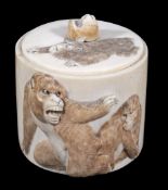 A circular Japanese ivory box and cover  ,  the sides carved in relief with monkeys,  8cm high
