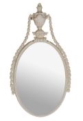 A white painted oval carton-pierre mirror  , circa 1775 and later,  with a white painted frame