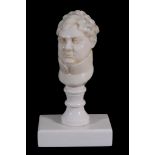 An ivory bust of George IV,   on a later baluster desk seal stem and oblong base,  12cm high