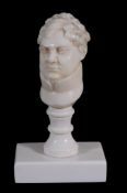 An ivory bust of George IV,   on a later baluster desk seal stem and oblong base,  12cm high