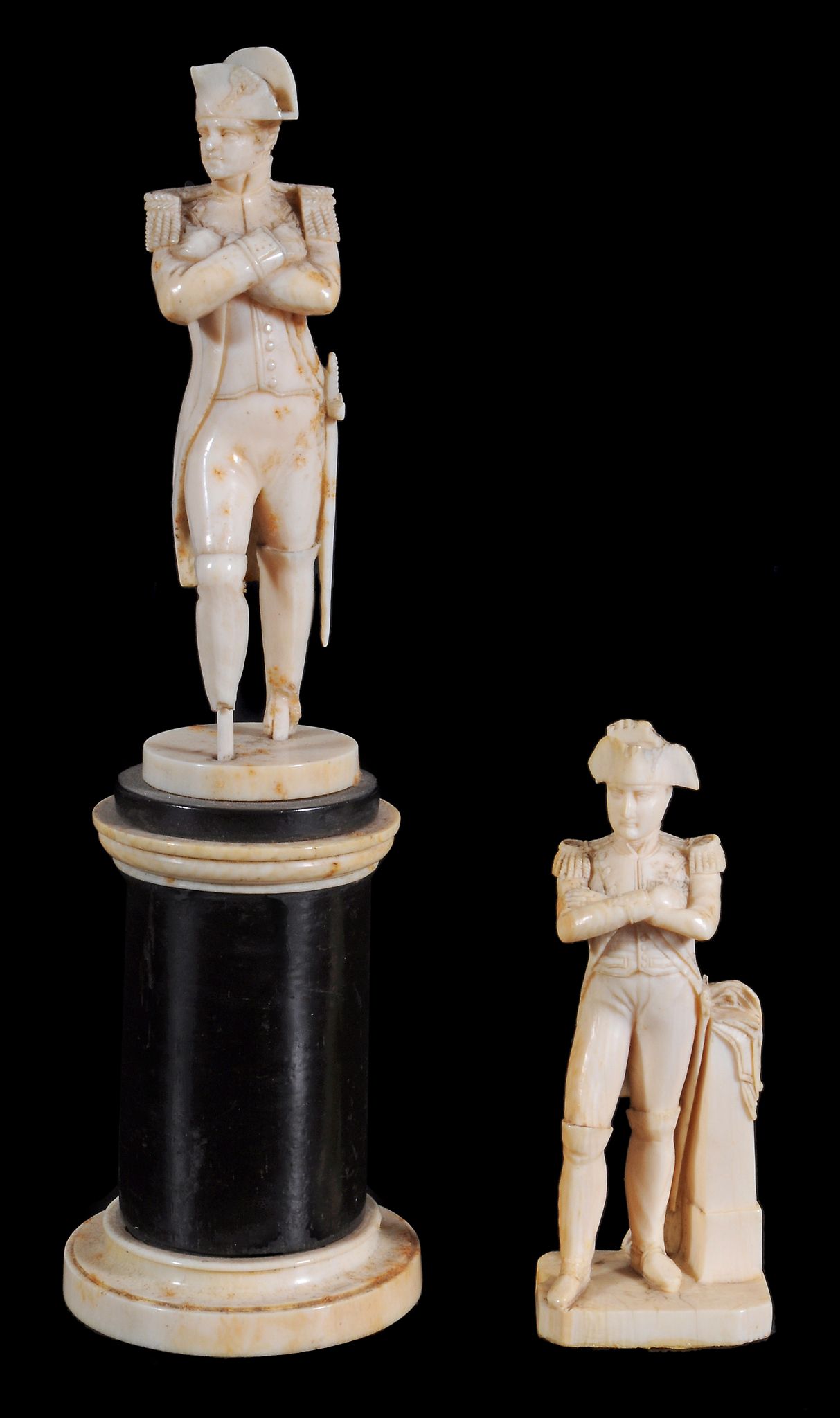 A Dieppe ivory figure of Napoleon,    standing with folded arms on a small circular base (damaged),