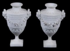 A pair of French bisque porcelain urns,   19th century , with mask handles suspended with garlands