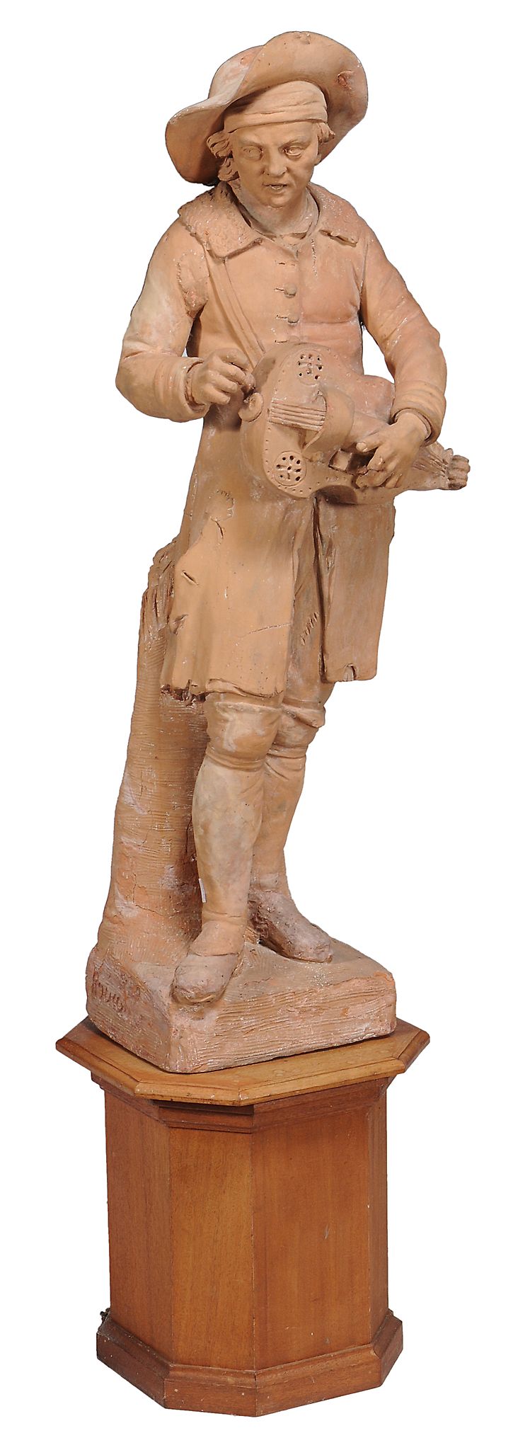 A late 18th century French large terracotta figure of a hurdy gurdy player after F. Roucourt  ,