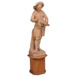 A late 18th century French large terracotta figure of a hurdy gurdy player after F. Roucourt  ,