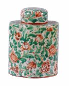 A Continental faience canister and cover  ,  decorated in green and red  with foliage, 14.5cm high