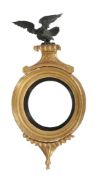 A Regency giltwood convex mirror  , circa 1815, surmounted by an eagle 94cm high, 46cm wide