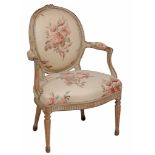 A Louis XVI armchair  , circa 1775,  with a padded oval back, seat and armpads, the moulded and