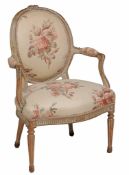 A Louis XVI armchair  , circa 1775,  with a padded oval back, seat and armpads, the moulded and