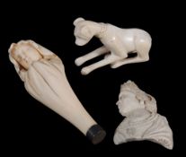 An ivory seal, carved as a bust of a child veiled in a shroud, 19th century, the matrix