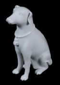 A decorative Chinese white figure of a hound,   20th century,  seated on its haunches and with a