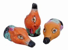 A pair of Staffordshire pottery fox mask stirrup cups  , second half 19th century,  each coloured