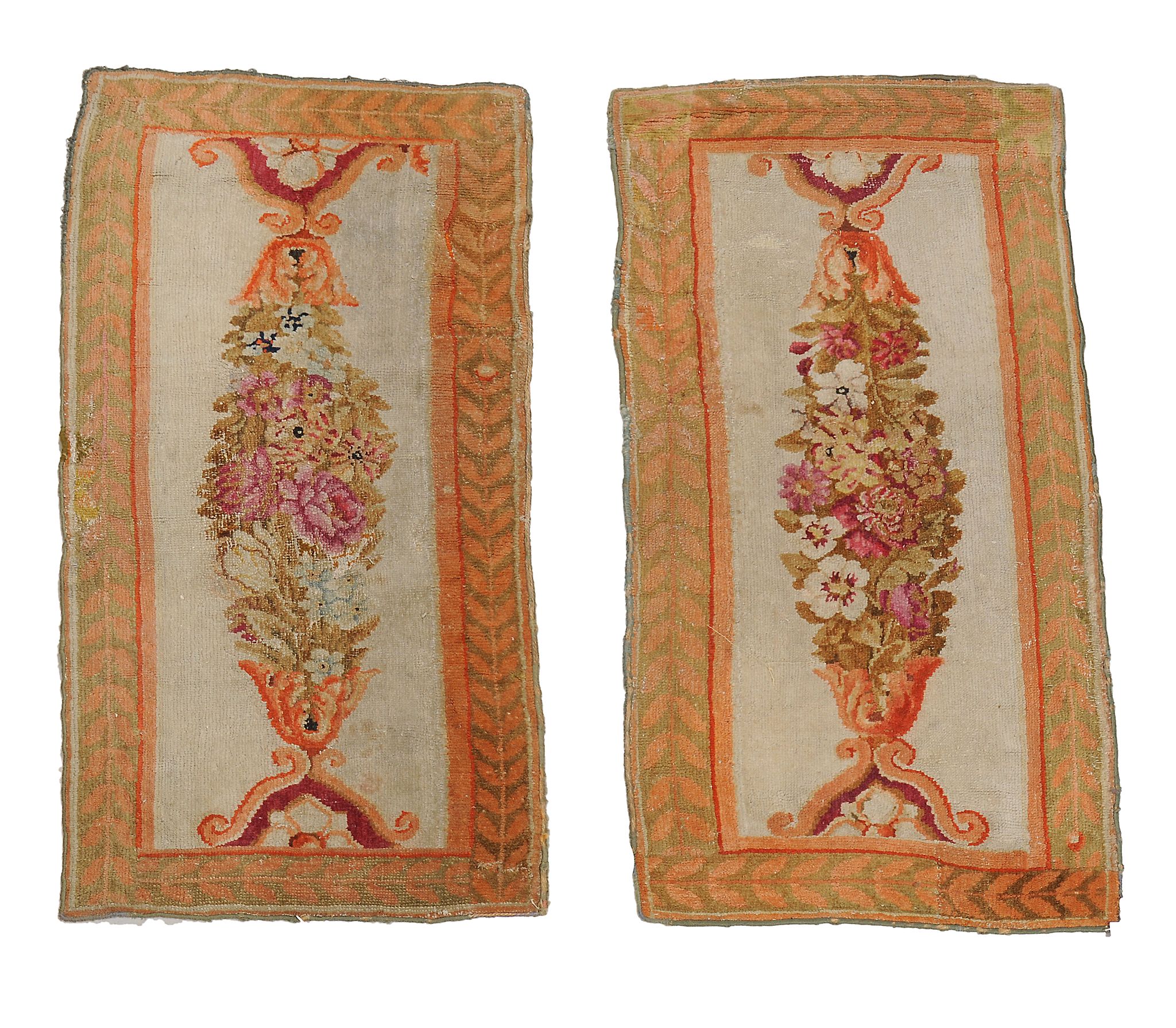 A pair of Savonnerie border fragments  , circa 1810,  each ivory panel with an ovoid polychrome