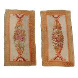 A pair of Savonnerie border fragments  , circa 1810,  each ivory panel with an ovoid polychrome