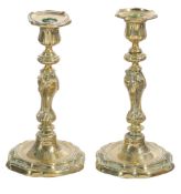 A pair of French brass candlesticks,   19th century,  of rococo design, with wrythen baluster stem